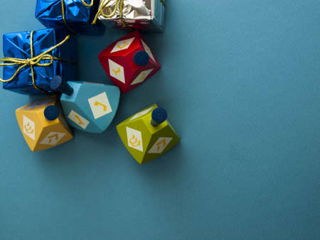 Colorful dreidels with presents on blue background.の写真素材