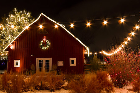 Historic farm decorated with Christmas lights.