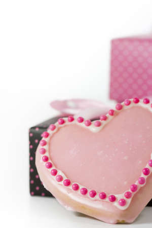 Heart shape pink cookie with icing.の写真素材