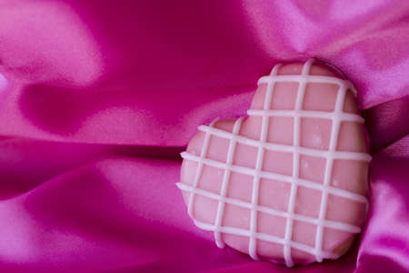 Heart shape pink cookie with icing.の写真素材