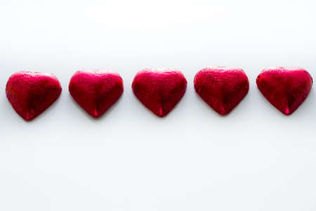 Heart shape chocolate candies on white background.の写真素材