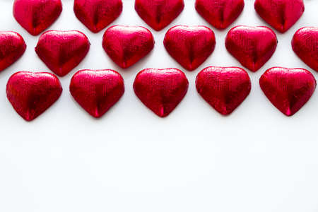 Heart shape chocolate candies on white background.の写真素材