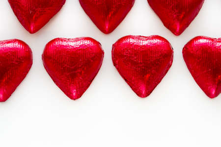 Heart shape chocolate candies on white background.の写真素材