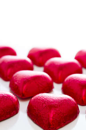 Heart shape chocolate candies on white background.の写真素材