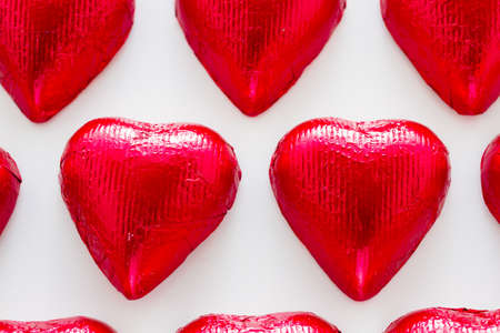 Heart shape chocolate candies on white background.の写真素材