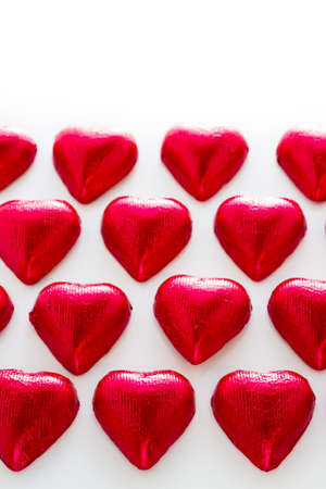 Heart shape chocolate candies on white background.の写真素材