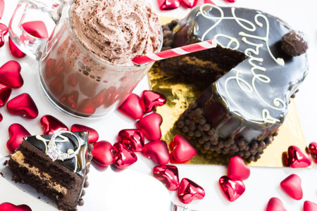 Heart shaped salted caramel cake on white background.の写真素材