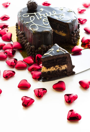 Heart shaped salted caramel cake on white background.