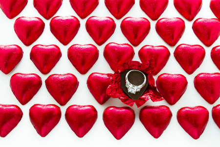 Heart shape chocolate candies wrapped in red foil for Valentine's Day.の写真素材