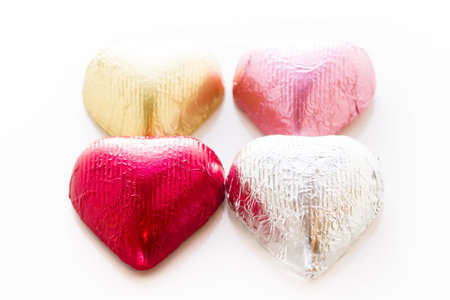 Heart shape chocolate candies wrapped in colorful foil for Valentine's Day.