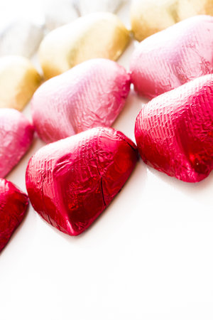 Heart shape chocolate candies wrapped in colorful foil for Valentine's Day.の写真素材