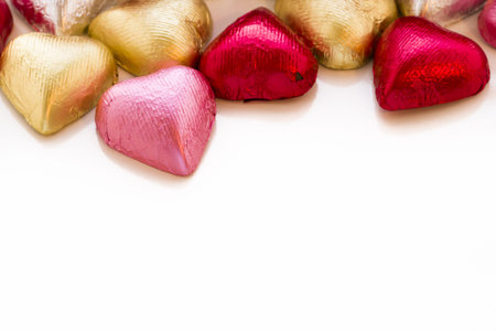 Heart shape chocolate candies wrapped in colorful foil for Valentine's Day.の写真素材