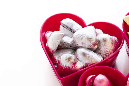 Heart shape chocolate candies wrapped in colorful foil for Valentine's Day.の写真素材