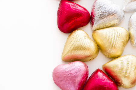 Heart shape chocolate candies wrapped in colorful foil for Valentine's Day.の写真素材