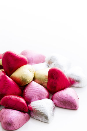 Heart shape chocolate candies wrapped in colorful foil for Valentine's Day.