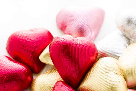 Heart shape chocolate candies wrapped in colorful foil for Valentine's Day.の写真素材