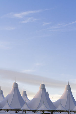 Tents of DIA at sunrise. Denver International Airport well known for peaked roof. Design of roof is...