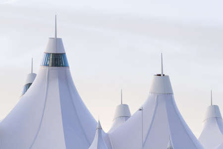 Tents of DIA at sunrise. Denver International Airport well known for peaked roof. Design of roof is reflecting snow-capped mountains.のeditorial素材