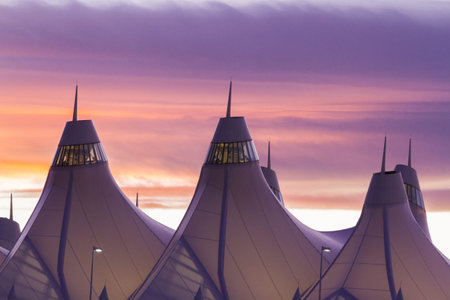 Glowing tents of DIA at sunrise. Denver International Airport well known for peaked roof. Design of...