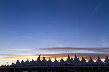 Tents of DIA at sunrise. Denver International Airport well known for peaked roof. Design of roof is reflecting snow-capped mountains.のeditorial素材