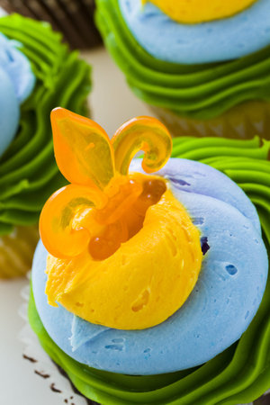 Fancy cupcakes decorated with leaf and mask for Mardi Gras party.の写真素材