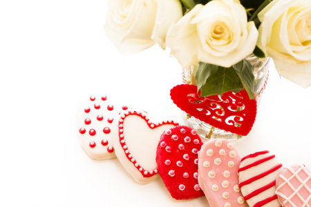 Gourmet cookies with bouquet of white roses.の写真素材