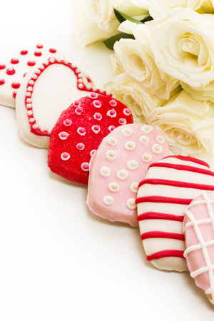 Gourmet cookies with bouquet of white roses.の写真素材