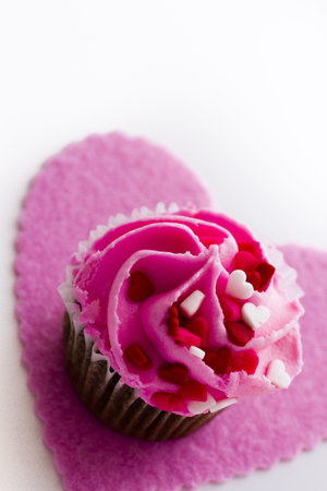 Chocolate cupcake with pink icing decorated for Valentine's Day.