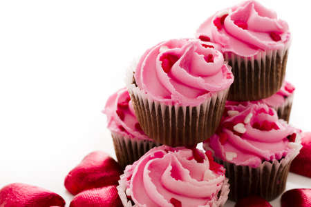 Stack of pink cupcakes with engagement ring on top.の写真素材