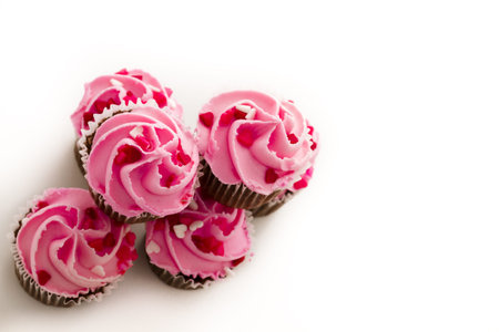 Stack of pink cupcakes with engagement ring on top.の写真素材