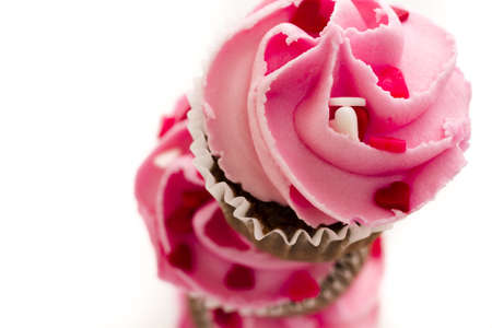 Stack of pink cupcakes on white background.の写真素材