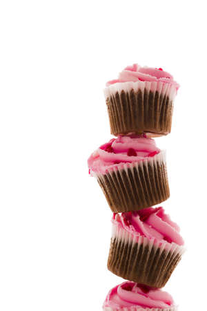 Stack of pink cupcakes on white background.の写真素材