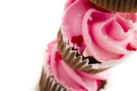 Stack of pink cupcakes on white background.の写真素材