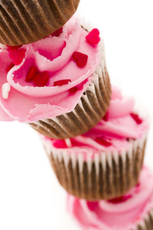 Stack of pink cupcakes on white background.の写真素材