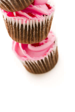 Stack of pink cupcakes on white background.の写真素材
