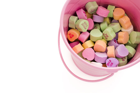 Conversation heart candies in pink bucket.の写真素材
