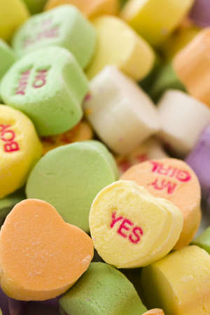 Pile of conversation heart candies on white background.の写真素材