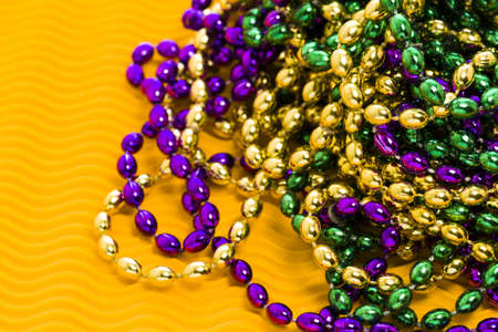 Mardi Gras beads yellow backgound.の写真素材