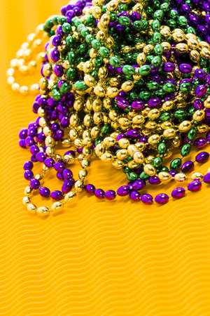 Mardi Gras beads yellow backgound.の写真素材