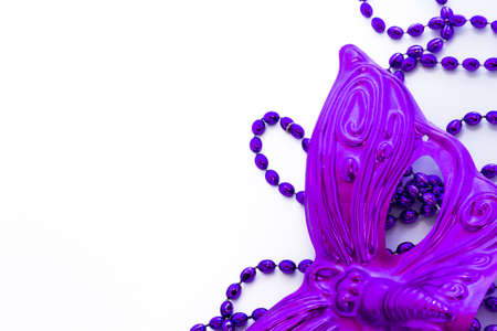 Mardi Gras purple beads and purple mask on white backgound.の写真素材