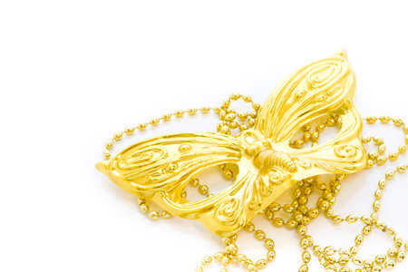 Mardi Gras gold beads and mask on white backgound.の写真素材