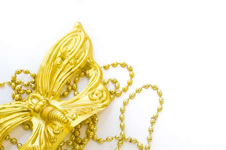Mardi Gras gold beads and mask on white backgound.の写真素材