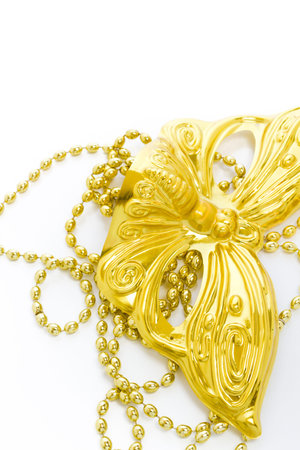 Mardi Gras gold beads and mask on white backgound.の写真素材