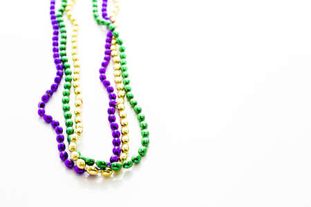 Multi color Mardi Gras beads on white background.の写真素材