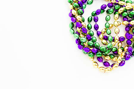 Multi color Mardi Gras beads on white background.の写真素材