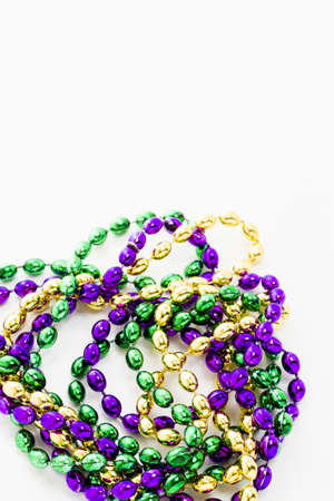Multi color Mardi Gras beads on white background.の写真素材