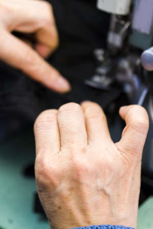 Hands work a sewing machine.の写真素材