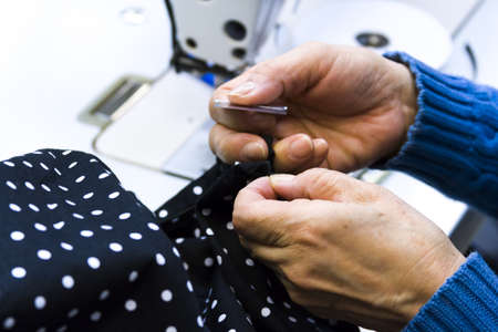 Hands work a sewing machine.の写真素材