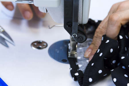 Hands work a sewing machine.の写真素材