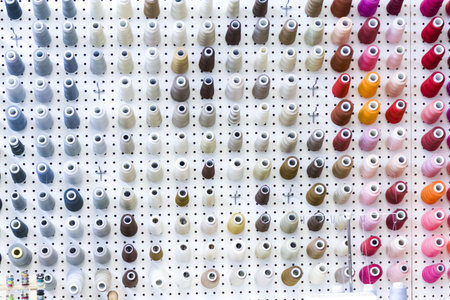 Colorful spools of thread on the wall in tailor shop.